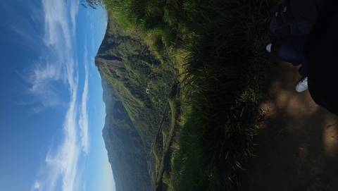 Panoramic view of green mountain landscape.
