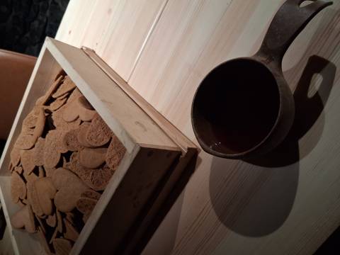 Tray of gingerbread cookies and a cup on a wooden table.