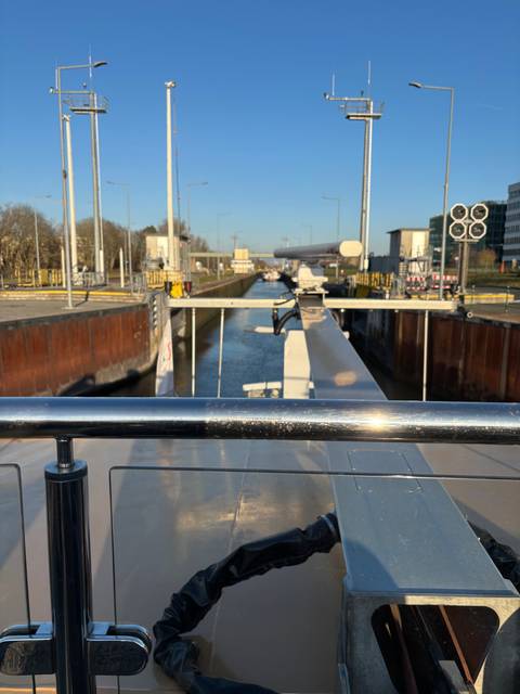 View of a boat deck approaching a lock on a canal.