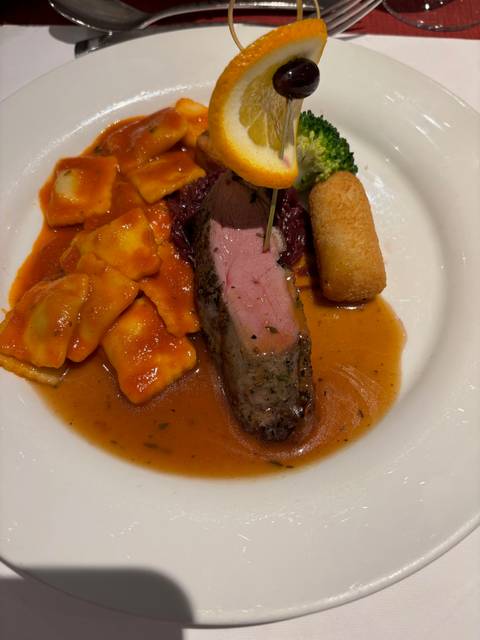       Plate of gourmet food with a sauce.
  