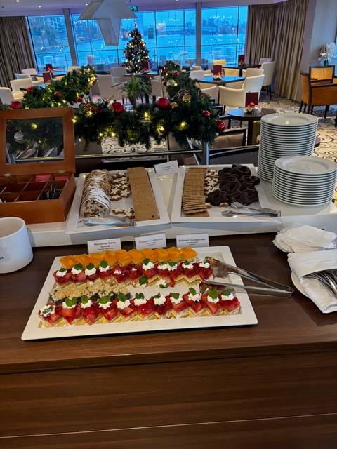 Buffet of desserts and pastries with holiday decorations.