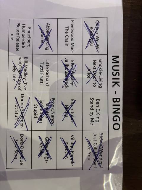 Partially obscured text on a music bingo sheet.