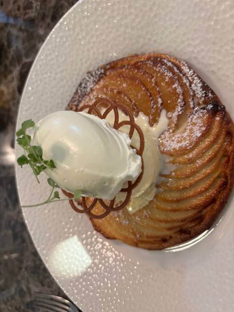 Dessert topped with ice cream and decorative elements.