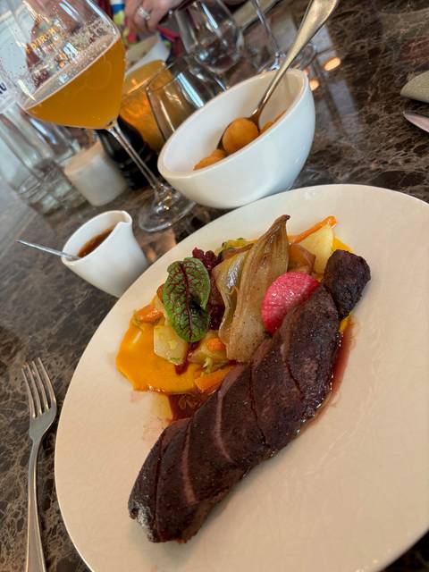       Plate of assorted food with vegetables and meat.
  