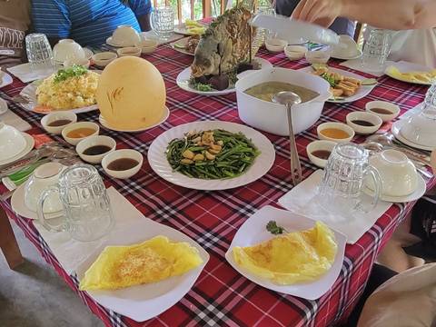 Traditional Vietnamese meal on a table with various dishes.