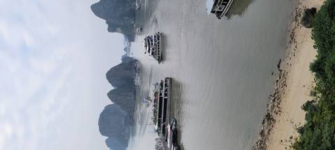 Beautiful view of Halong Bay with boats and karst formations.