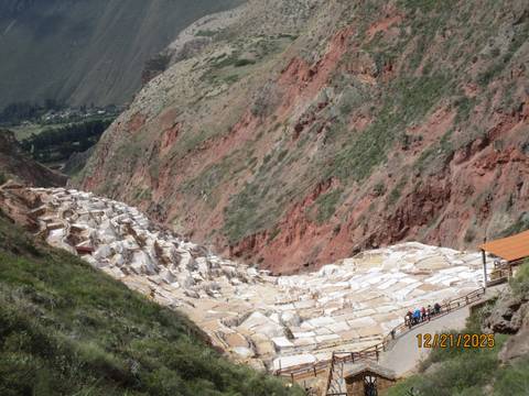 Terraced salt ponds in a red rocky landscape.