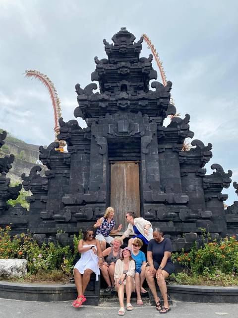 Couple posing by an ancient stone temple.