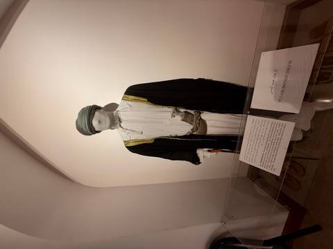 Museum exhibit of a traditional Omani garment on display.