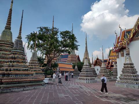       Wat Pho with people exploring the grounds.
  