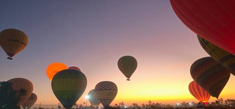 Hot air balloons in the sky during sunset.