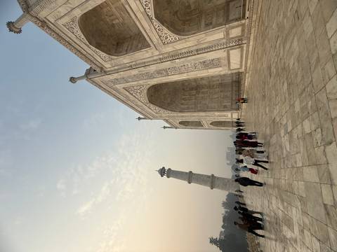       Taj Mahal with tourists in the foreground
  