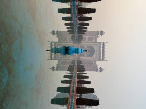       Reflective pool leading to an archway, with a blue decoration
  