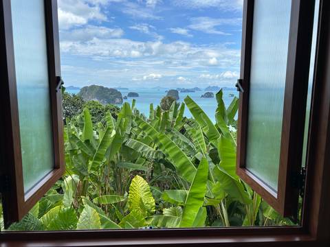       Scenic view of islands and sea through an open window.
  