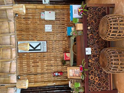Reception desk area of a hotel with bamboo interior.