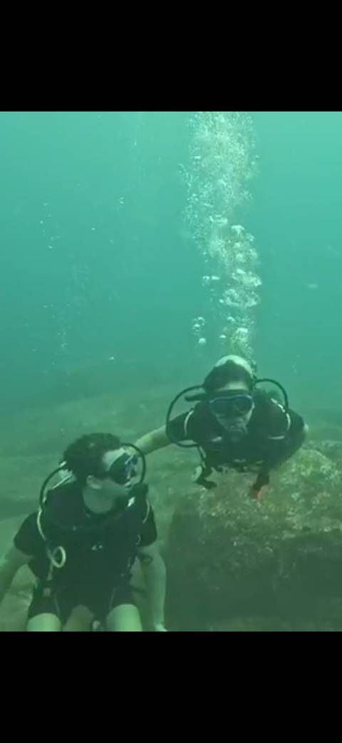 Underwater diving scene with two individuals.