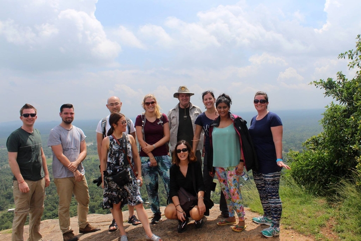 Group photo of people on a hilltop.