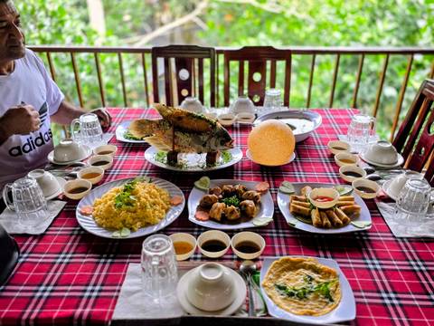 Traditional Vietnamese meal on a table, including fish and rice dishes.