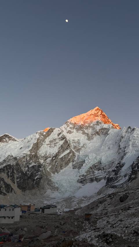 Sunlit snowy mountain peak.