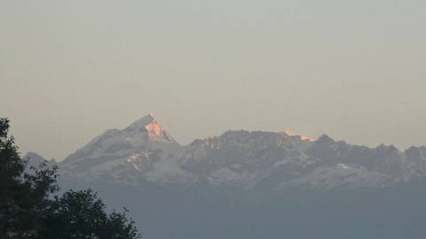 A mountain peak with snow in the distance.