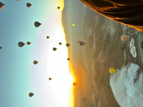 Hot air balloons floating in the sky during sunrise.