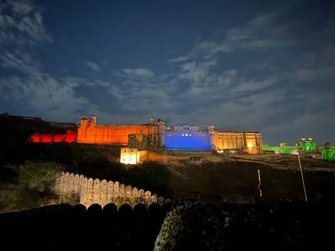       Fort illuminated with colorful lights at night.
  