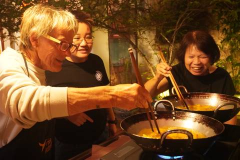 Participants in a cooking class enjoying cooking together.