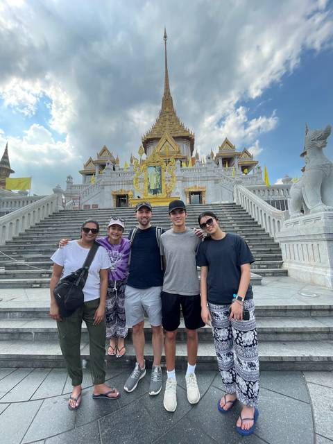 Group posing at the steps of a temple.