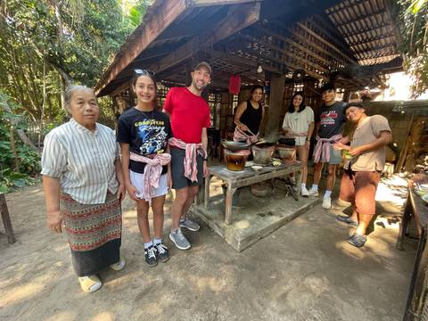 Group cooking class in a rustic setting.