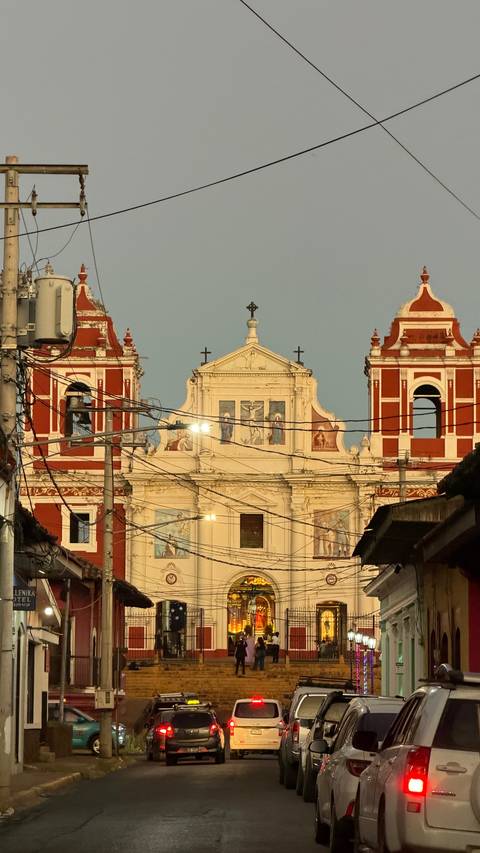       Facade of a colorful church with wires in the foreground.
  