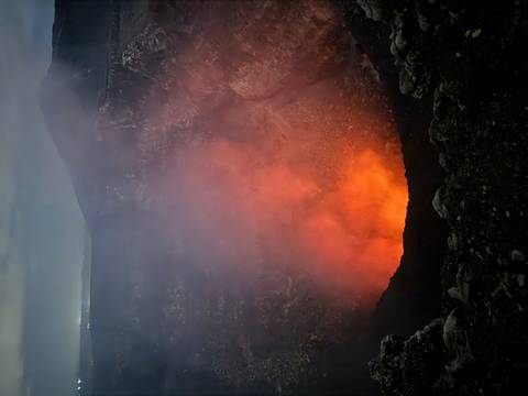       Volcano crater emitting lava and smoke in dark surroundings.
  