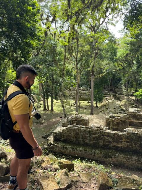       Man observing an ancient Mayan archaeological site.
  