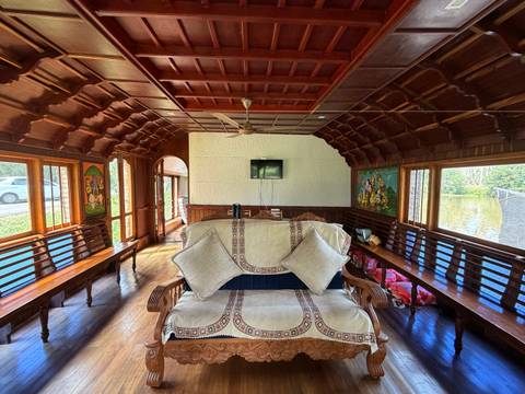       Interior view of a wooden houseboat with seating.
  