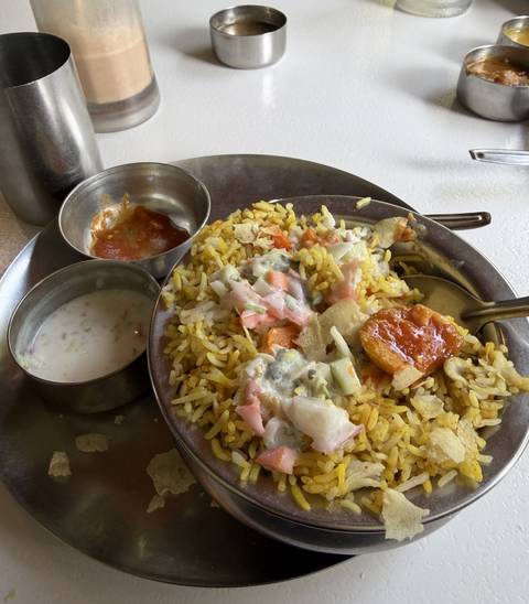       Plated dish with rice, curry, and sides.
  