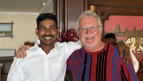 Two men smiling and posing for a photo.