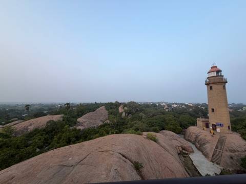       Old lighthouse with surrounding natural landscape.
  