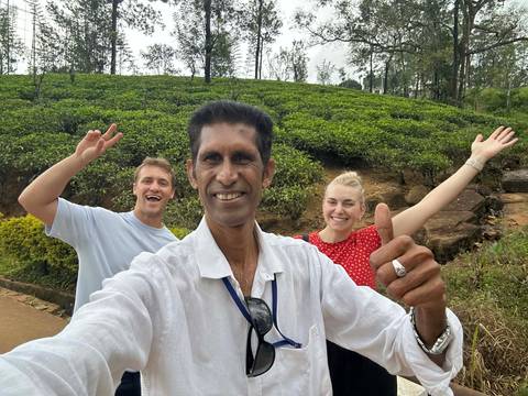 Group taking a selfie at a tea plantation.
