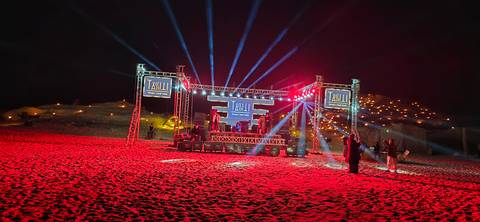 Concert stage set up in the desert at night.
