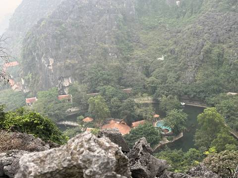 Hilltop view of a resort nestled in a forested mountain area.