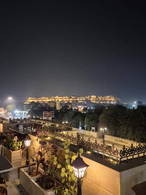       Nighttime view of a large, illuminated fort.
  