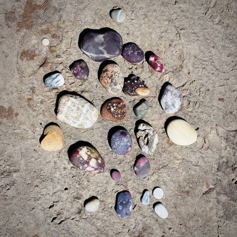 Colorful stones arranged on the ground.