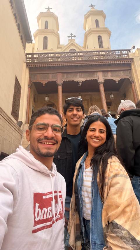 Group photo with an ancient Egyptian building in the background.