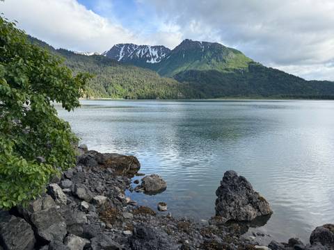       Scenic view of a lake with a snow-capped mountain backdrop.
  