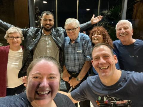 Group of people smiling and posing for a photo.