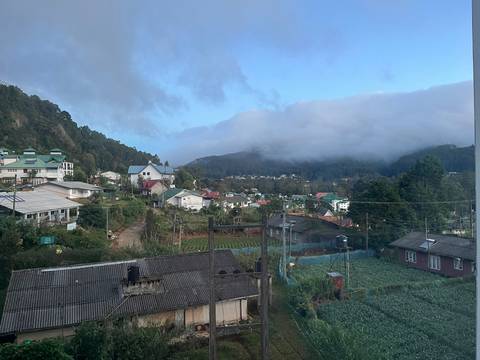       Mountain town with scattered buildings seen from a distance.
  