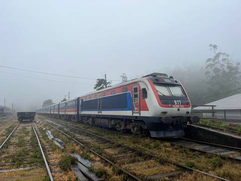       A train on railway tracks in a foggy environment.
  