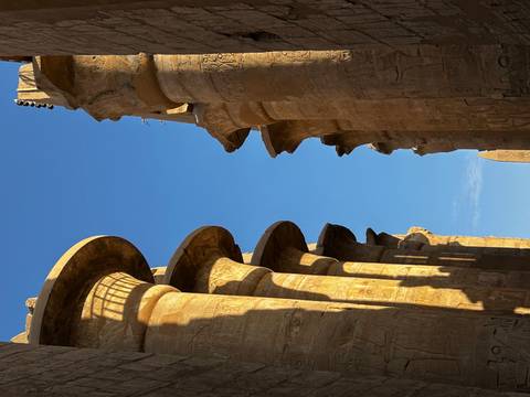       Tall columns with hieroglyphics and sunlight streaming through.
  