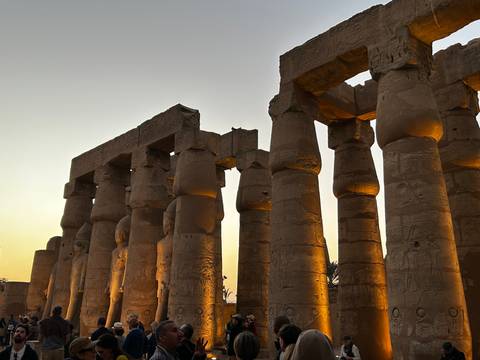       Ancient columns at sunset with warm lighting highlighting them.
  