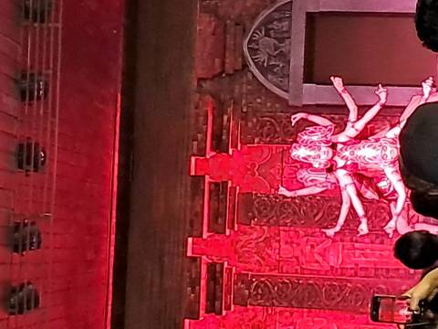 Stage performance with red lighting and performers