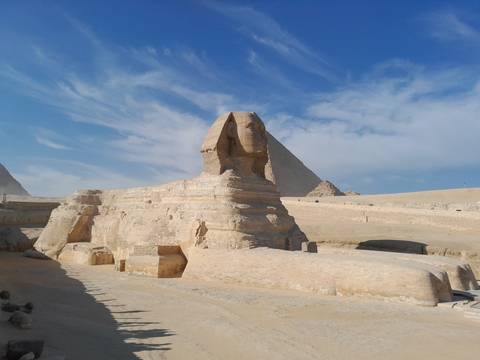       Sphinx with a pyramid in the background.
  